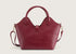 Back view of the dark red leather handbag featuring smooth leather texture and refined stitching.