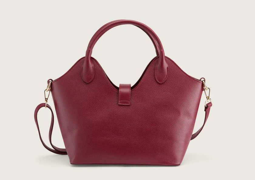 Back view of the dark red leather handbag featuring smooth leather texture and refined stitching.