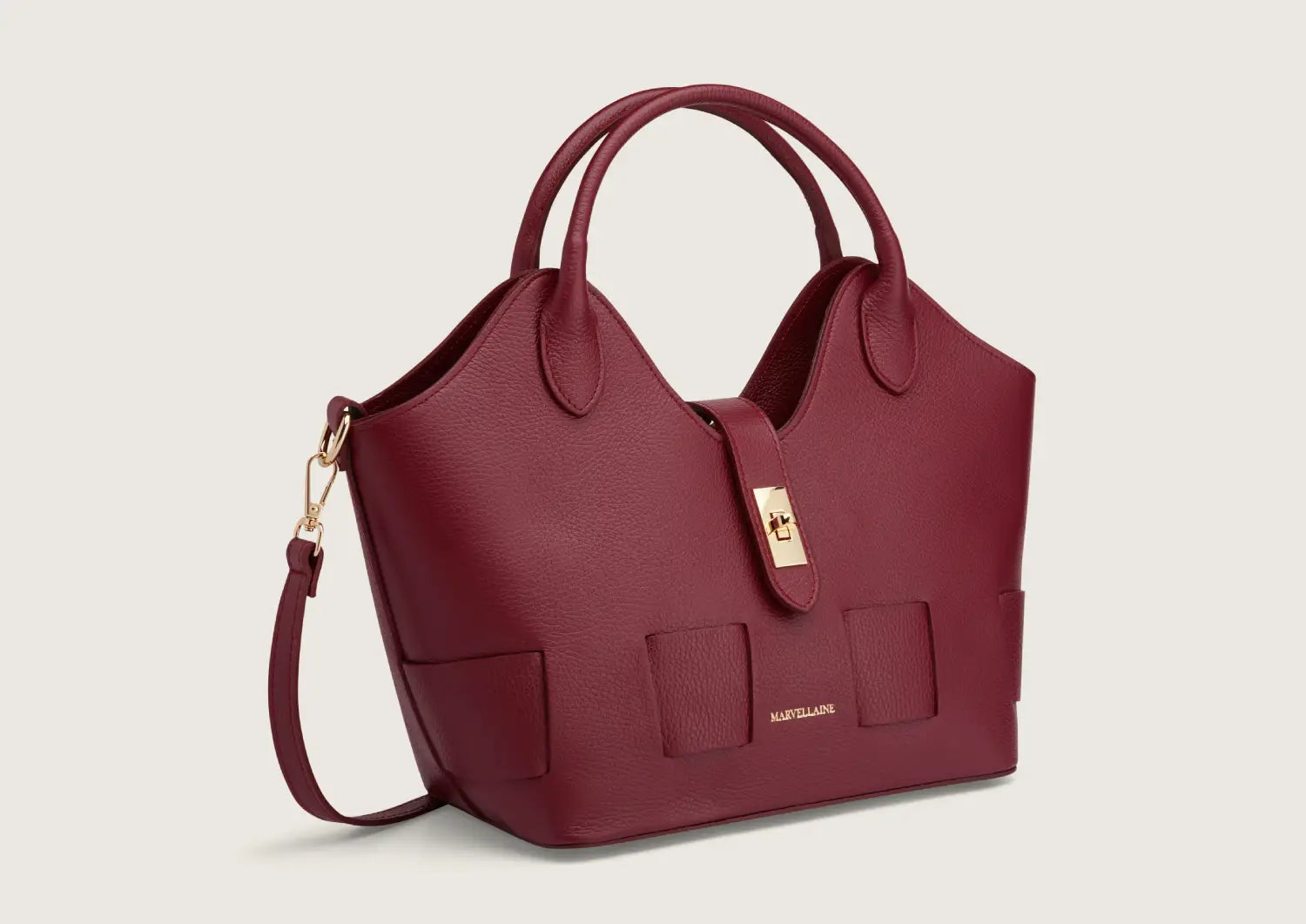 Chic dark red leather handbag with structured shape and elegant top handles.