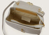 Close-up of the grey leather shoulder bag highlighting the secure zip closure.