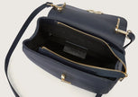 Close-up of the navy blue leather shoulder bag showing the sturdy zip closure detail.