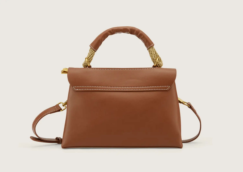 Back view of a genuine leather crossbody bag showing rear pocket detail.